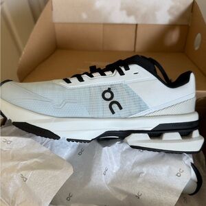 On Running White and Black Athletic Shoes